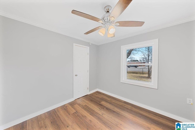 empty room featuring ceiling fan, ornamental molding, and wood-type flooring