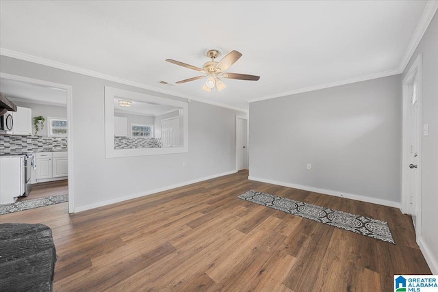 empty room with crown molding, wood-type flooring, and ceiling fan