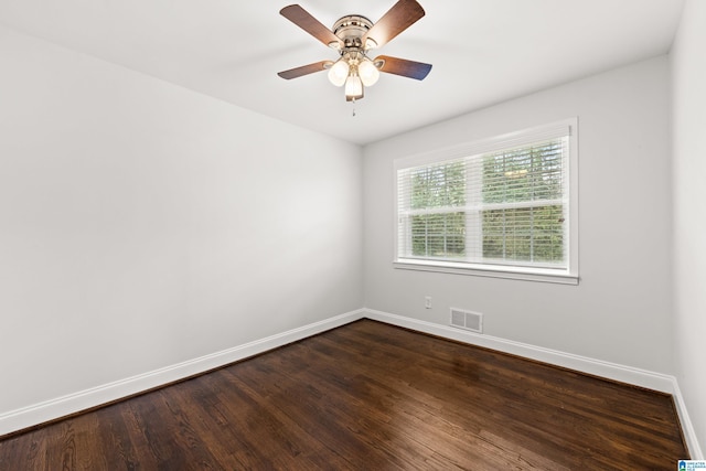 empty room featuring dark hardwood / wood-style flooring and ceiling fan