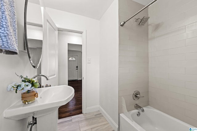 bathroom featuring tiled shower / bath combo and wood-type flooring