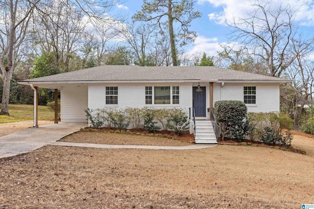 ranch-style home featuring a carport