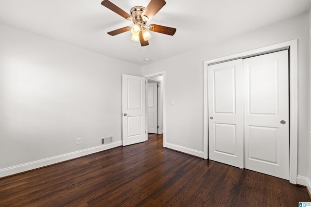 unfurnished bedroom featuring dark hardwood / wood-style flooring, a closet, and ceiling fan