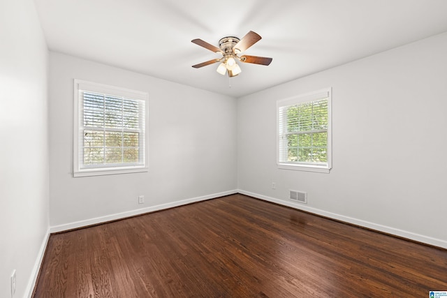 spare room featuring dark hardwood / wood-style floors and ceiling fan