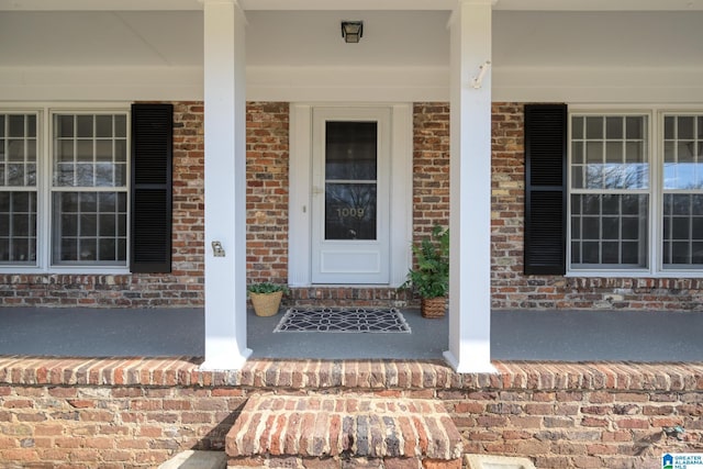 view of exterior entry with covered porch