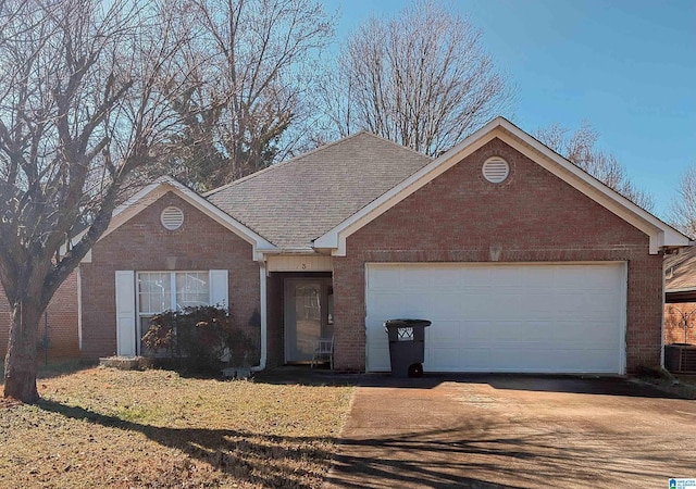 single story home with an attached garage, brick siding, concrete driveway, and roof with shingles