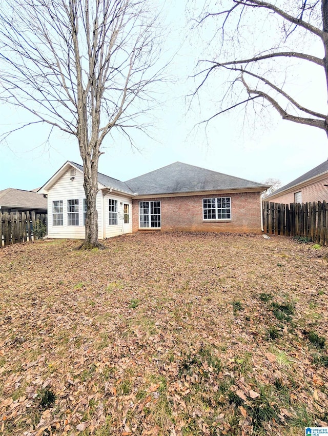 back of house with fence