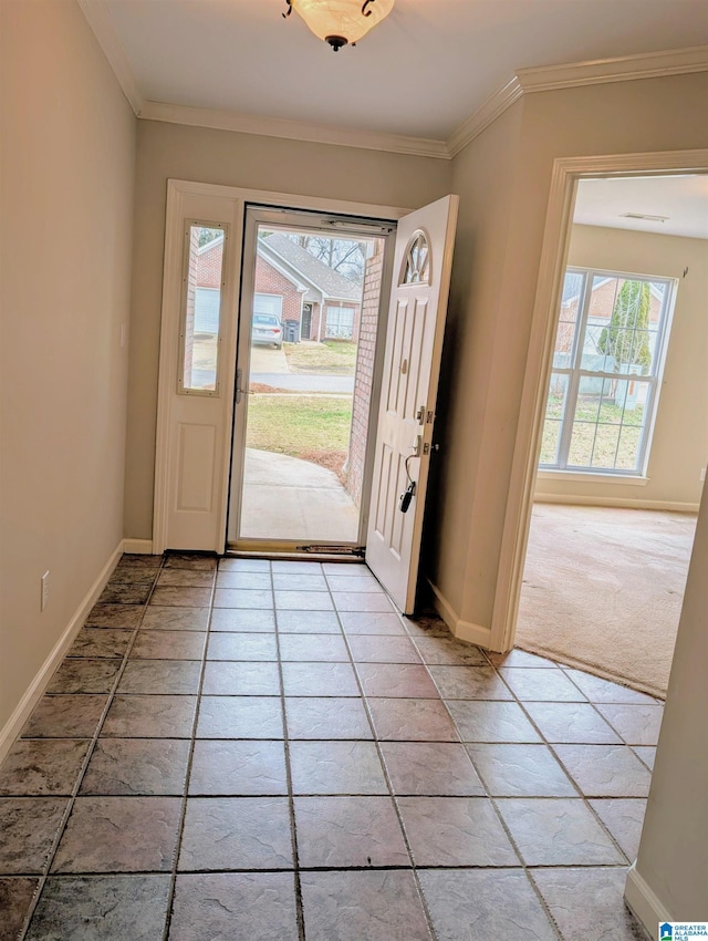 entryway with baseboards, light tile patterned flooring, light colored carpet, and crown molding