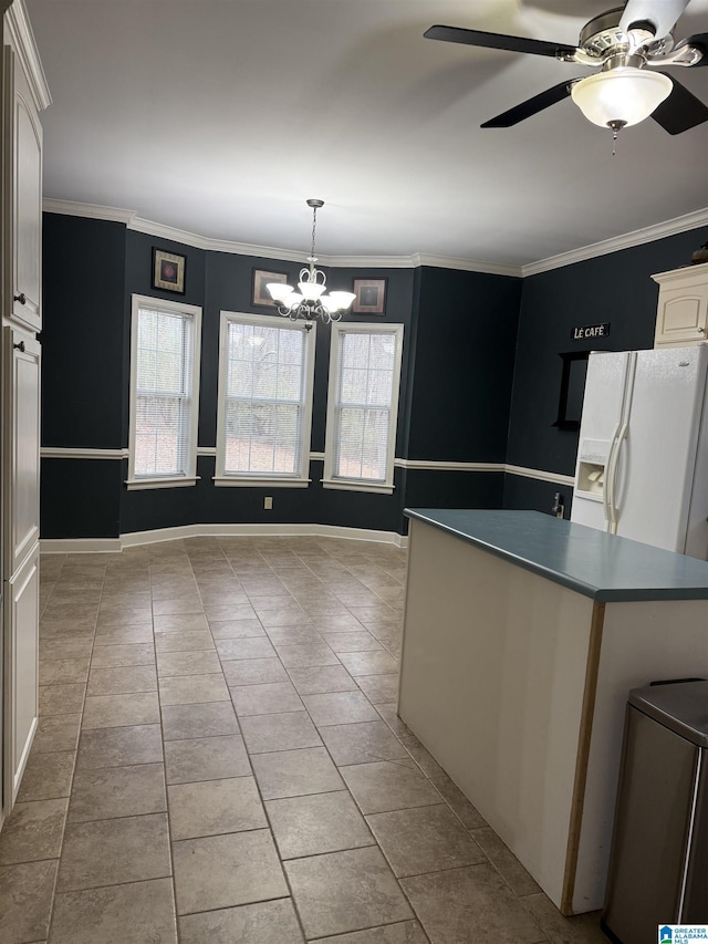 kitchen featuring ornamental molding, white refrigerator with ice dispenser, and a wealth of natural light