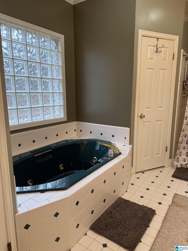 bathroom with tiled bath and tile patterned flooring