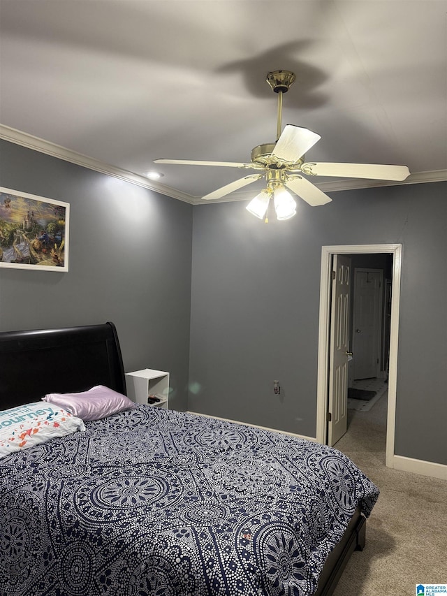 carpeted bedroom featuring crown molding and ceiling fan