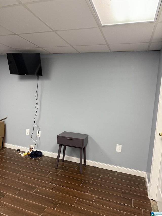 basement with a paneled ceiling