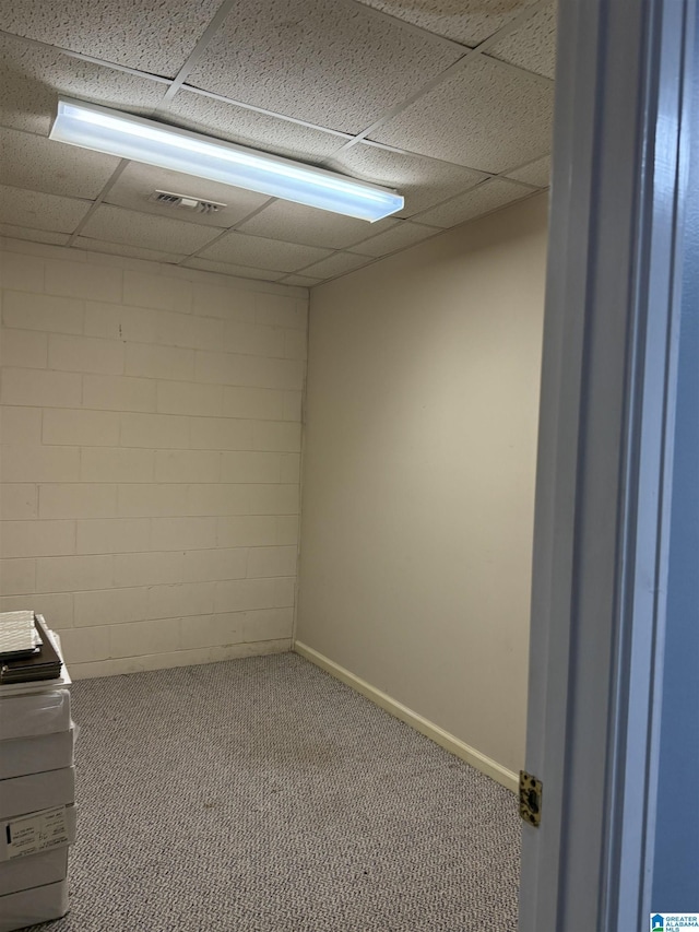 basement featuring carpet flooring and a drop ceiling