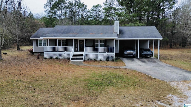 view of front of house featuring a front yard, a carport, and covered porch