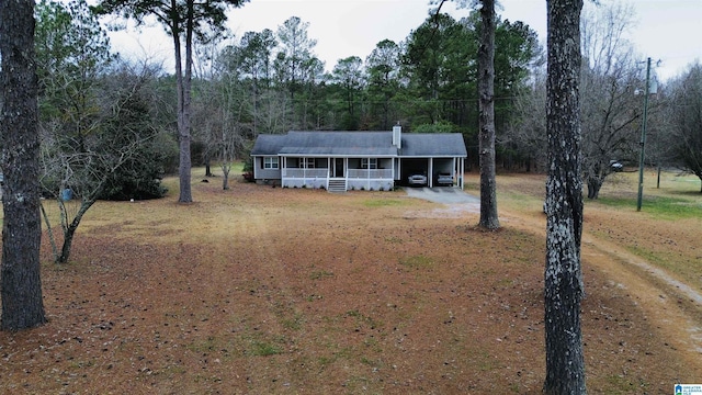 view of front of home featuring a carport and covered porch