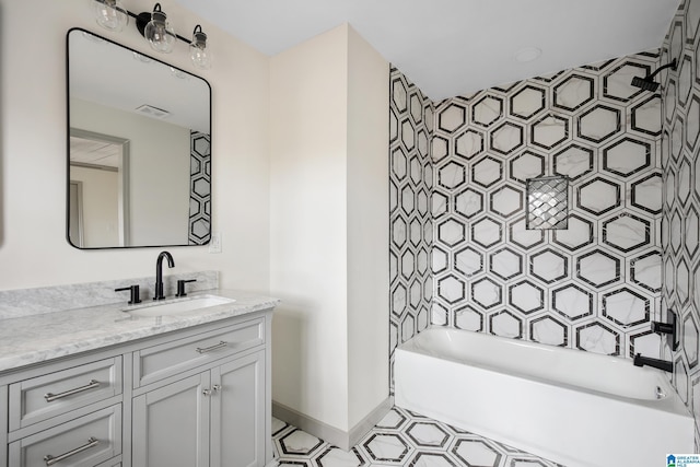 bathroom with vanity and tiled shower / bath combo