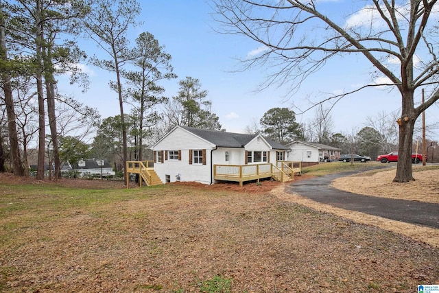 back of house with a wooden deck and a yard