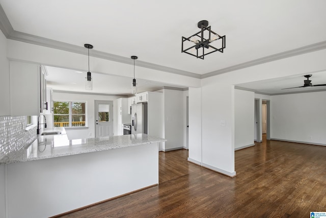 kitchen with sink, white cabinetry, stainless steel fridge with ice dispenser, decorative light fixtures, and kitchen peninsula