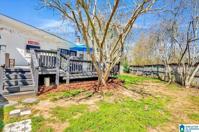 view of yard featuring fence and a wooden deck