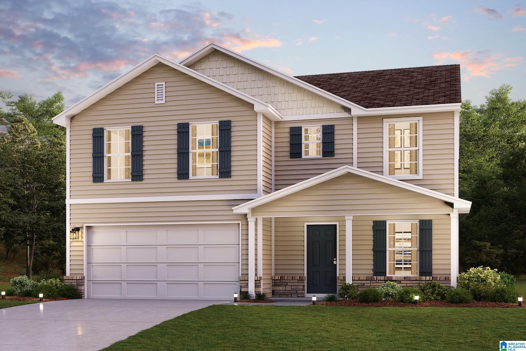 view of front of house featuring a garage and a yard