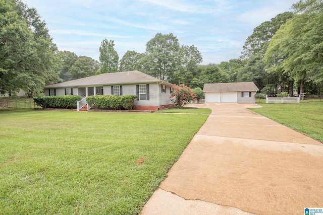 single story home with an outbuilding, a garage, and a front yard