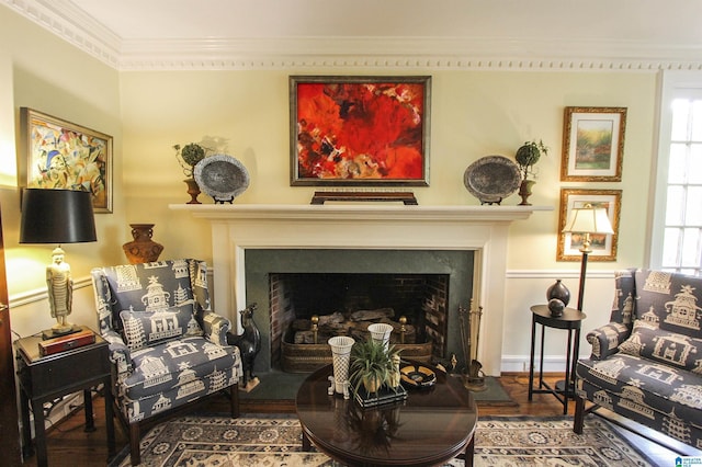 sitting room with hardwood / wood-style flooring and ornamental molding