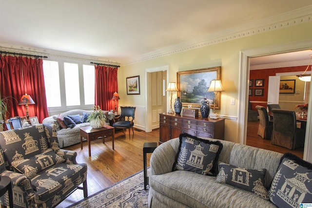 living room with hardwood / wood-style flooring and crown molding