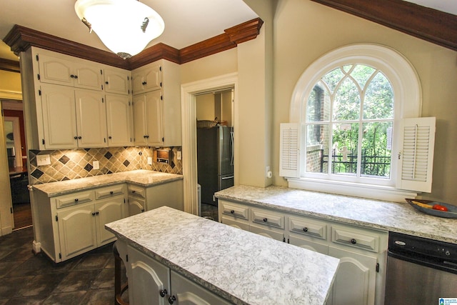 kitchen with stainless steel refrigerator, light stone countertops, a center island, and decorative backsplash