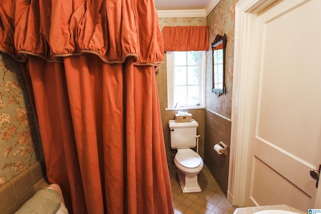 bathroom with ornamental molding, tile walls, and toilet