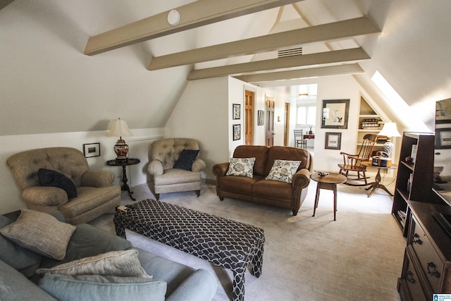 carpeted living room featuring vaulted ceiling with skylight