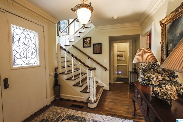 entrance foyer featuring ornamental molding and dark hardwood / wood-style flooring