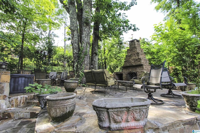 view of patio / terrace featuring an outdoor stone fireplace