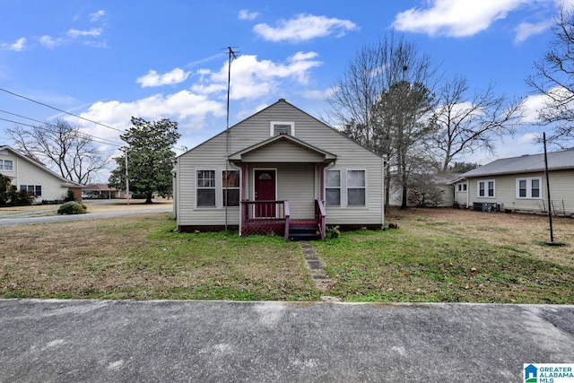 bungalow-style home with a front lawn