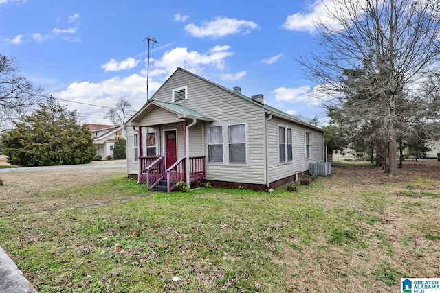 bungalow-style home featuring a front yard and central AC unit