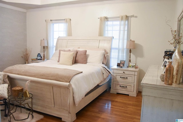 bedroom featuring crown molding and dark hardwood / wood-style floors