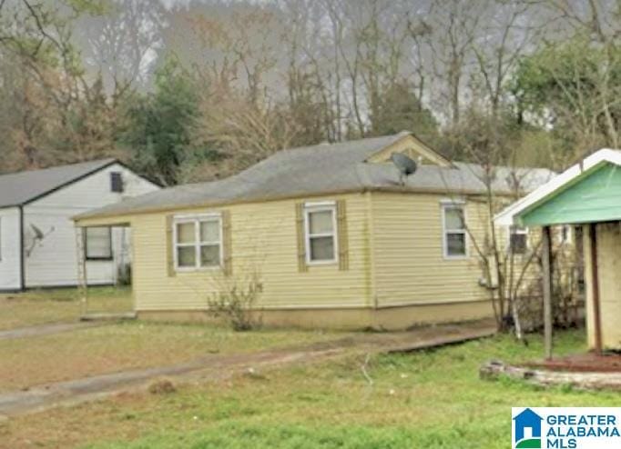 rear view of property featuring a yard