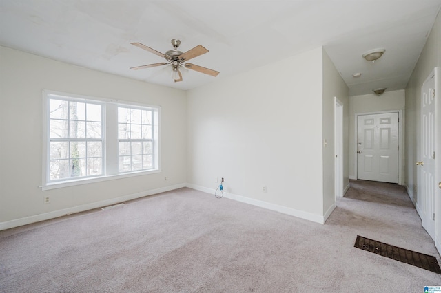 carpeted spare room with ceiling fan