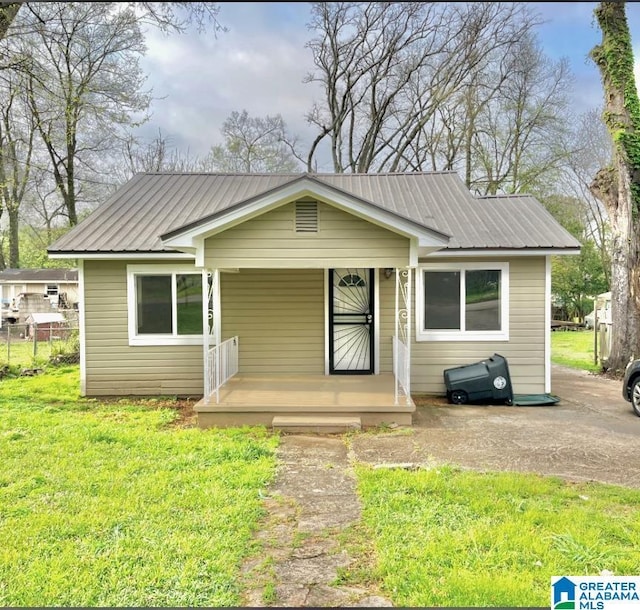 bungalow-style house featuring a porch and a front yard