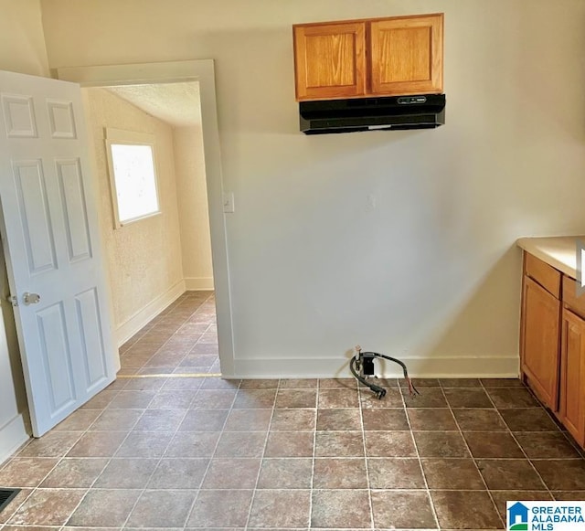 laundry area with tile patterned floors