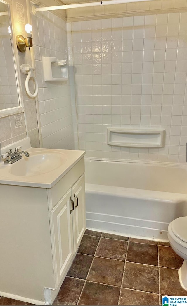 full bathroom with vanity, toilet, decorative backsplash, and shower / tub combination