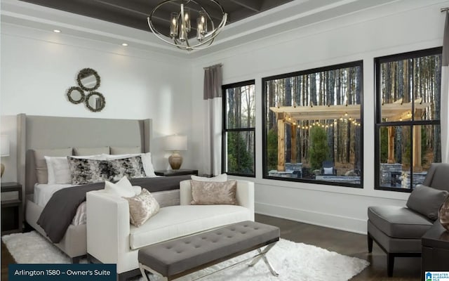 bedroom with a chandelier and hardwood / wood-style floors