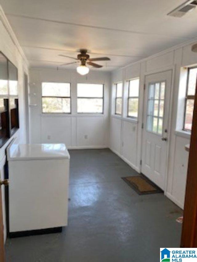 interior space with ceiling fan