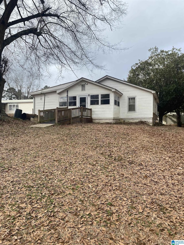 back of house with a deck