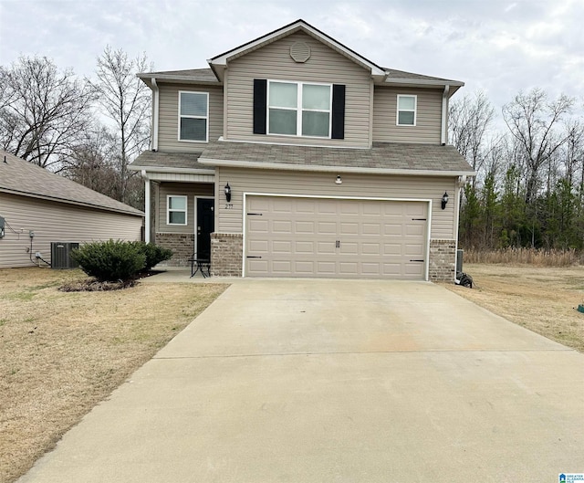 view of front facade with a garage and central AC