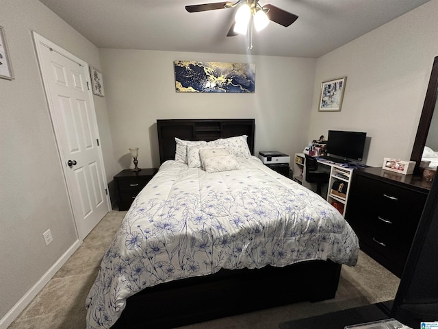 bedroom with ceiling fan and light carpet