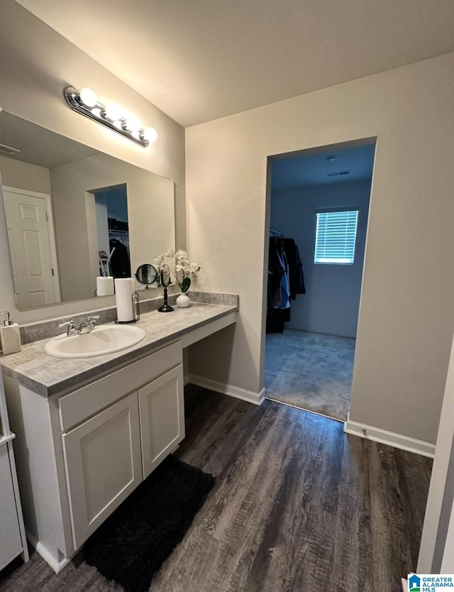 bathroom with hardwood / wood-style flooring and vanity