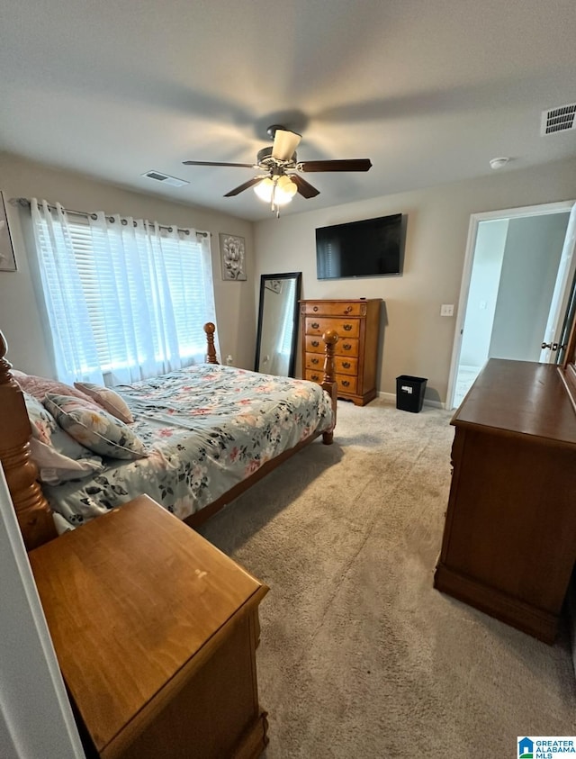 bedroom featuring ceiling fan and light carpet