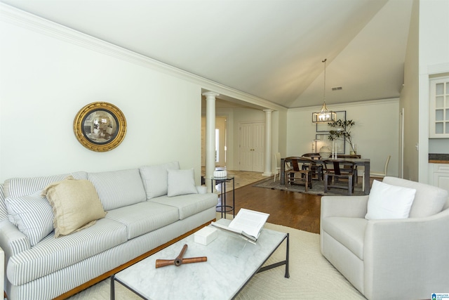 living room featuring crown molding, lofted ceiling, light hardwood / wood-style floors, and decorative columns