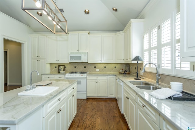 kitchen featuring hanging light fixtures, sink, white cabinets, and white appliances