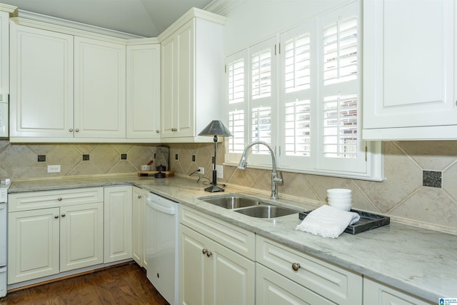 kitchen with sink, dishwasher, white cabinetry, light stone counters, and tasteful backsplash