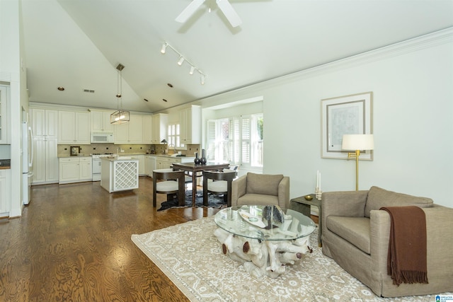 living room featuring dark hardwood / wood-style flooring, crown molding, vaulted ceiling, and ceiling fan